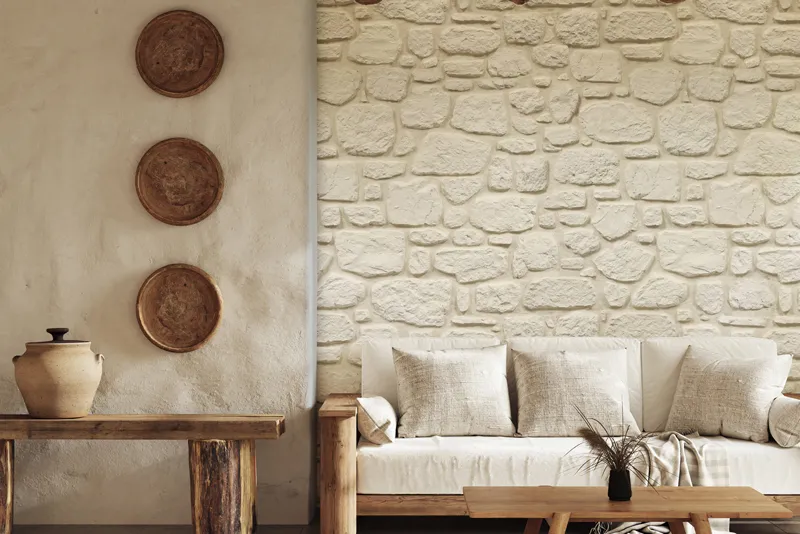 Interior space with light stone wall and wooden furniture.