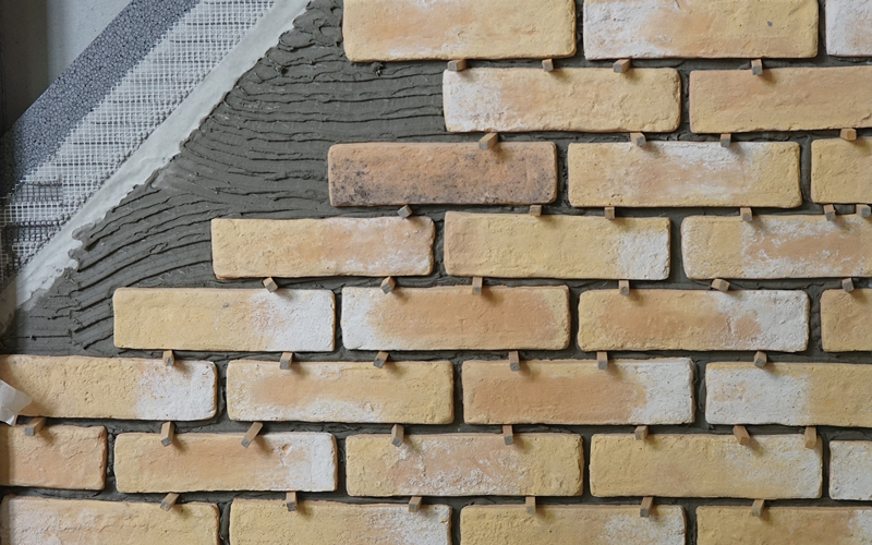 cross-section of natural stone wall showing insulation layers for energy efficiency