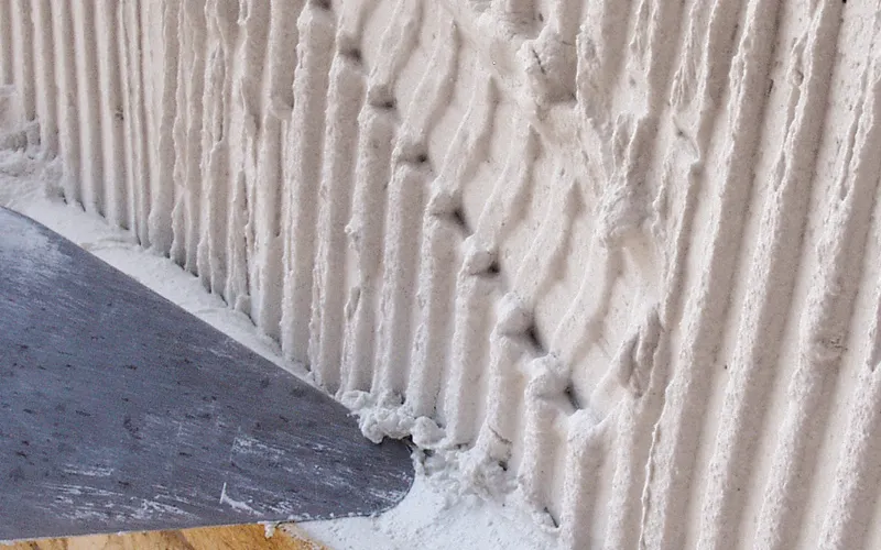 professional natural stone installation with full adhesive coverage