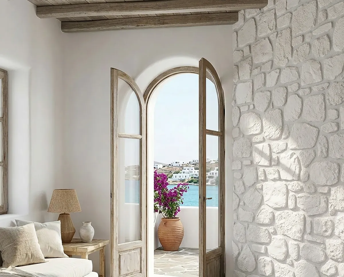 Cycladic living room with white stone wall and sea view